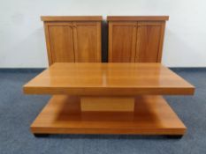 A pair of contemporary double door cabinets together with matching two tier coffee table in a pine