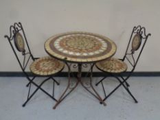 A three piece wrought iron and mosaic patio set
