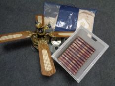 A ceiling fan together with a bag containing crocheted table linen and twelve volumes The New