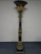 A decorative black and gilt floor standing uplighter