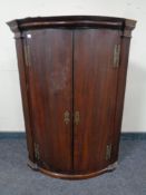 A George III double door hanging corner cabinet