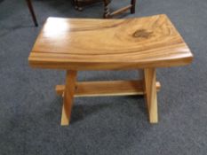 A contemporary hard wood curved stool