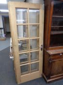 A pair of pine interior doors with glass inset panels, height 198 cm.
