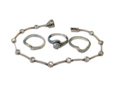 Three 9ct white gold diamond set rings, together with a silver bracelet.