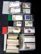 A box containing several folders of first day covers