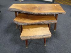 A nest of three rustic oak tables