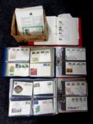 A box containing several folders of first day covers