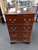 An audio cabinet in a mahogany finish together with a Philips HiFi with speakers