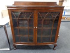 An early 20th century oak bow fronted,