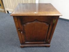 A Titchmarsh and Goodwin oak single door low cabinet