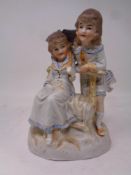 A Bisque figure of two girls