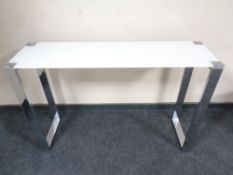 A contemporary glass topped side table