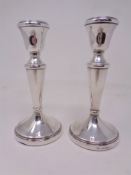 A pair of loaded silver candlesticks, Birmingham marks. Height 14.