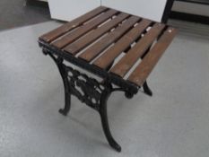 A cast iron wooden slatted patio occasional table, width 45 cm.