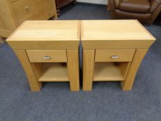 A pair of contemporary oak bedside tables fitted a drawer