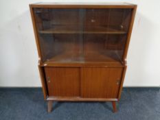A mid 20th century teak sliding glass door cabinet