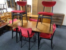 A mid 20th century walnut veneered dining room suite comprising of drop leaf dining table,