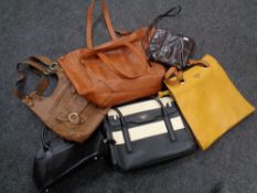 A box containing assorted leather handbags