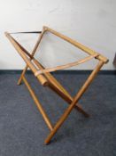 A folding fruit wood luggage cage stand