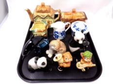 A tray containing Pendelfin ornaments, Poole pottery dolphin, cottage ware china,