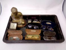 A quantity of antique and later spectacles, a small mantel clock,