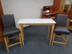 A contemporary marble topped breakfast bar table together with two breakfast bar chairs upholstered