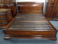 A mahogany effect 6' bed frame