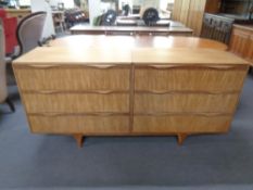 A mid 20th century teak six drawer block chest