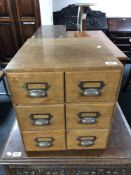 An early 20th century oak six drawer index chest