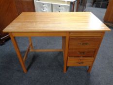 A 20th century teak single pedestal desk