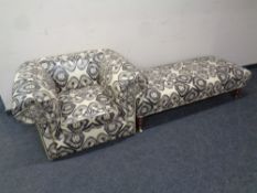 A club armchair and oversized foot stool upholstered in a vinyl