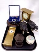 A tray containing a pair of carved hard wood and bone figures of elephants,