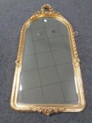 A gilt framed bevelled hall mirror decorated with roses.