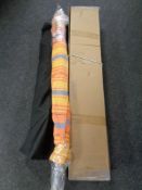 An awning in carry bag together with a boxed hammock