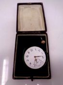 A vintage pocket watch face with winder in case