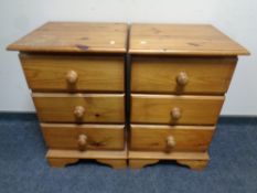 A pair of pine three drawer bedside chests