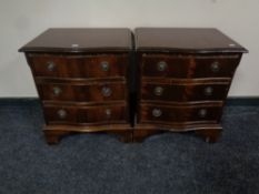 A pair of reproduction serpentine front bedside chests