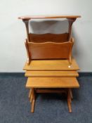 A teak nest of three tables and a magazine rack