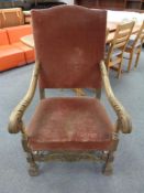 A 20th century carved oak framed high backed armchair