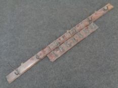 Two wall mounted coat racks with cast iron hooks