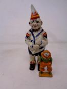 An antique hand painted cast iron clown money box, height 14 cm,