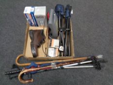 A box of steel toe capped boots, flask, foot pump, walking sticks,