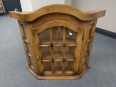 An oak single door wall cabinet
