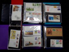 A box of five albums of first day covers