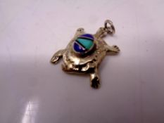 A white metal tortoise pendant
