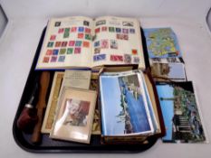 A tray of sew on patches, postcards, stamp album,