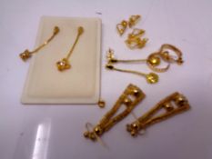 Five pairs of gold plated earrings