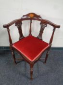 A corner armchair with red dralon seats