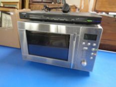 A Logik DVD player together with a microwave