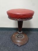 A Victorian turned rosewood circular piano stool